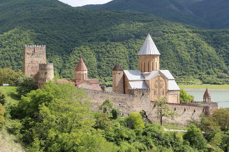 Ananuri fortress and its churches above the Zhinvali reservoir, surrounded by forest